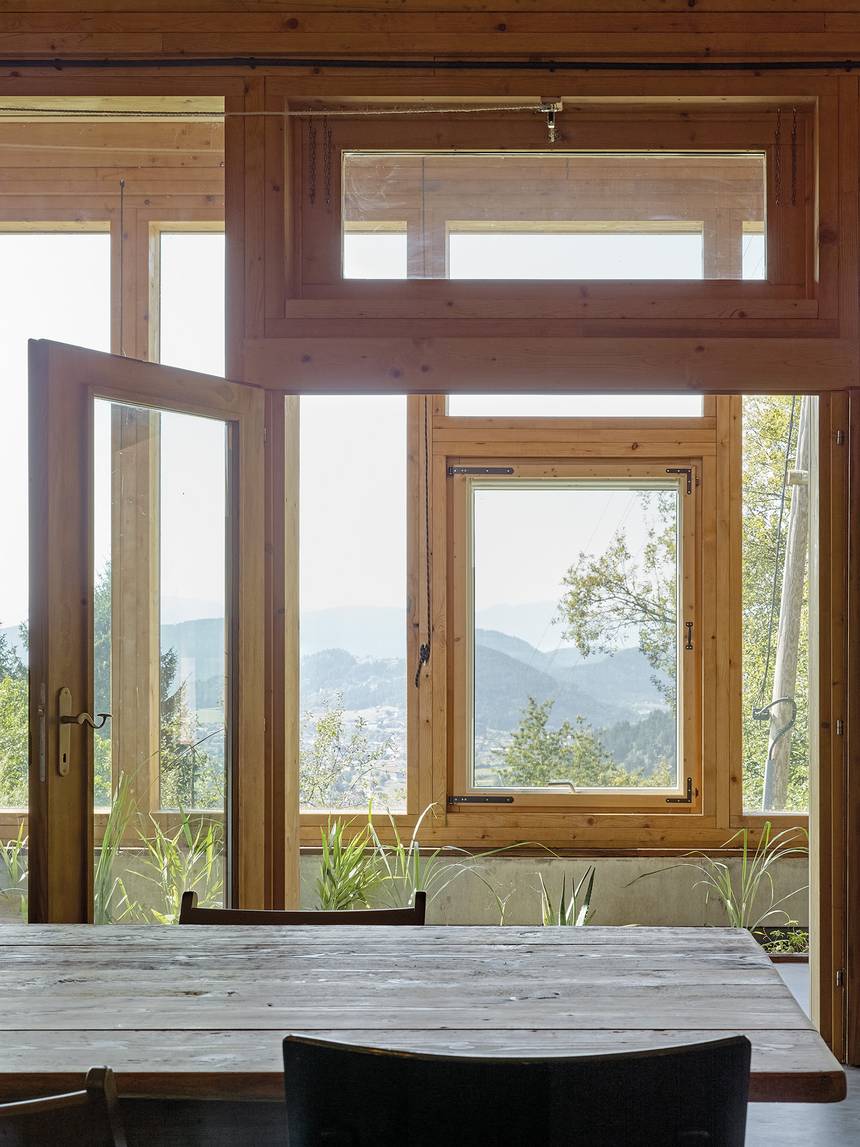 A timber window opening from the dining area to the landscape