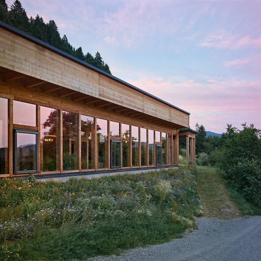 The long south facade glowing at dusk