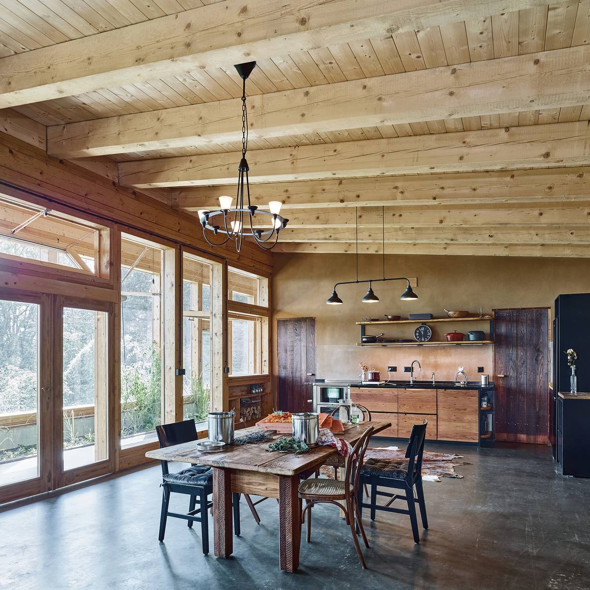 Open living, dining and kitchen space with timber ceiling