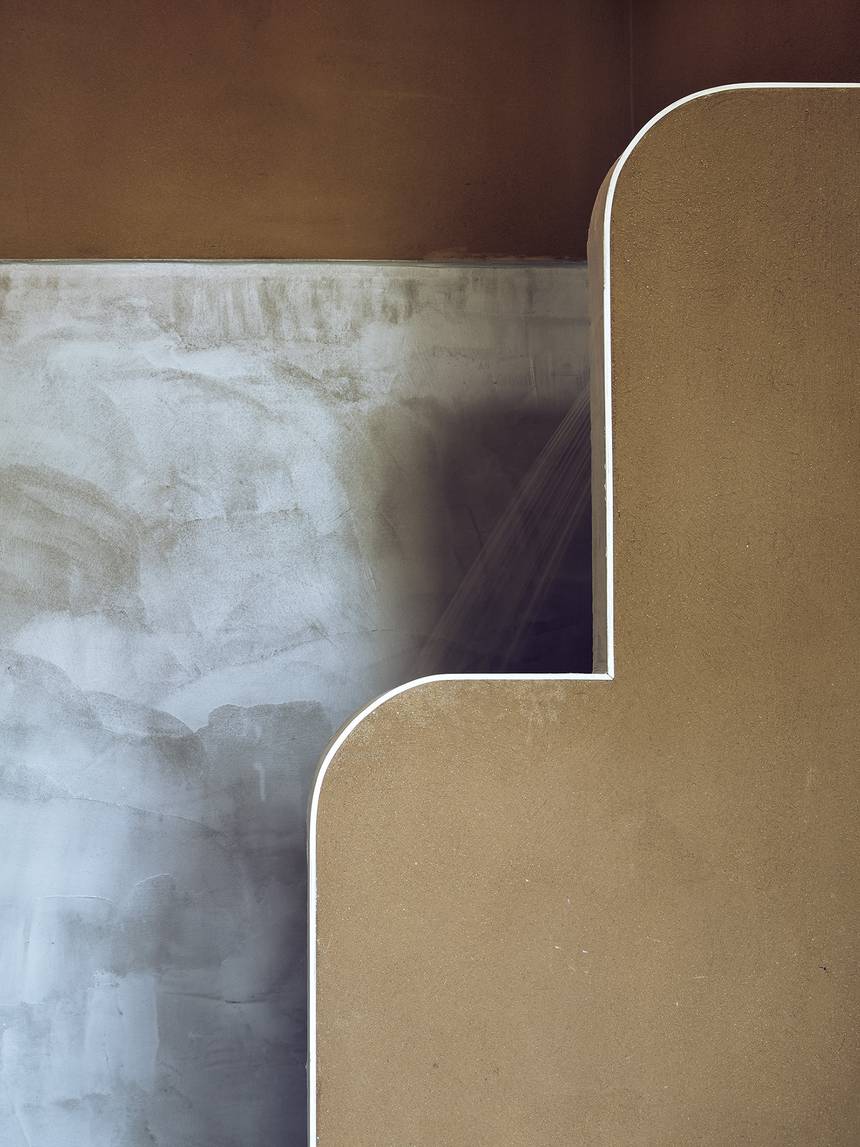 Hand-modelled clay meeting microcement in the shower